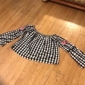 Black and white checkered off the Shoulder shirt.